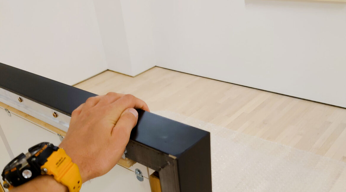 Art installer holds the picture