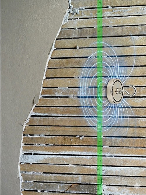 Finding studs in lath plaster walls by using super magnet.
